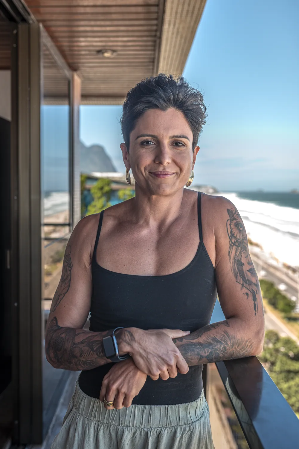 Nanny Faggiano na varanda, com o mar ao fundo